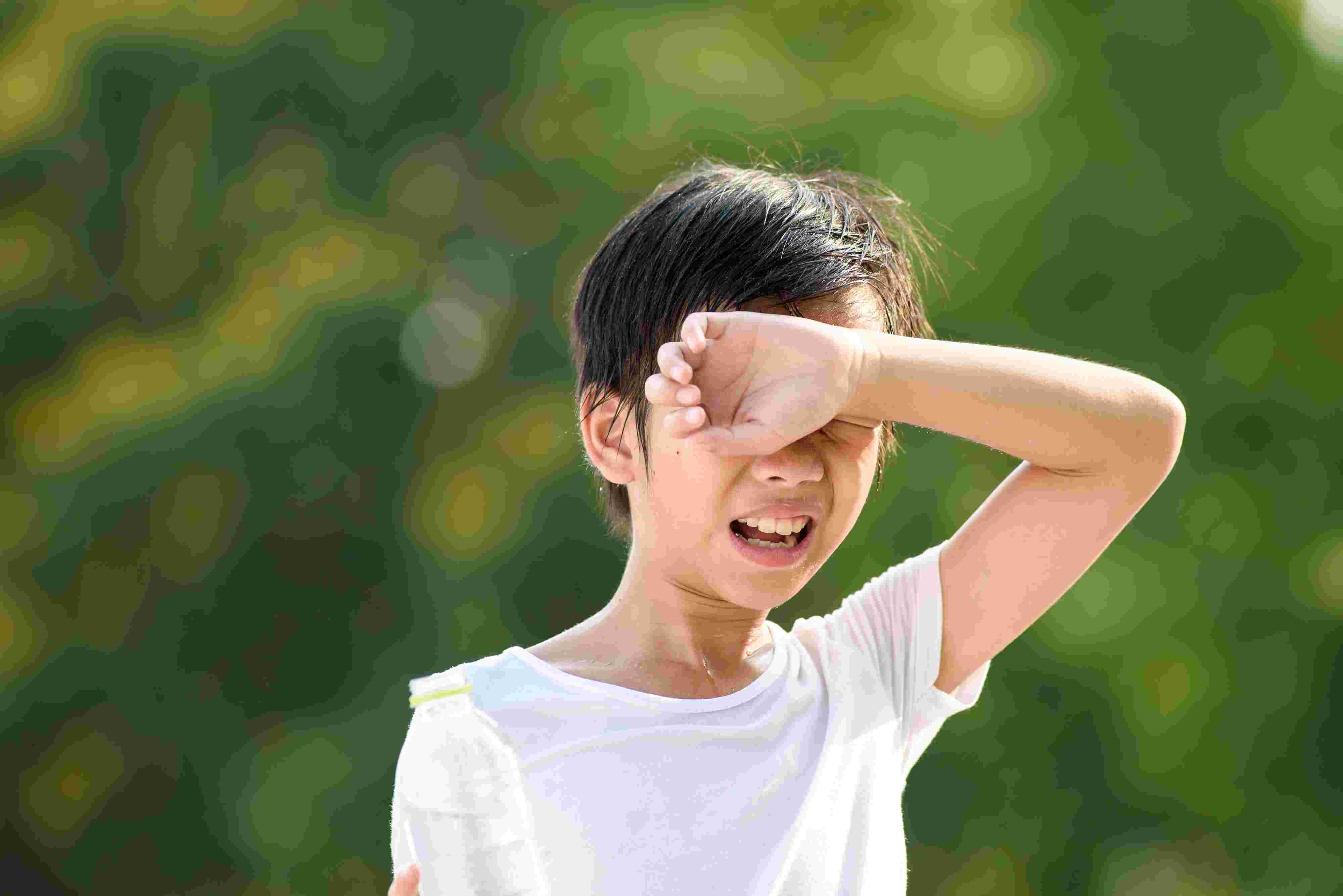 kid cries as sweat drips into his eyes