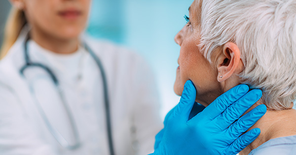 Provider examining patient's neck.