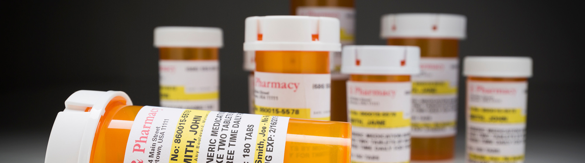 Multiple prescription pill bottles.