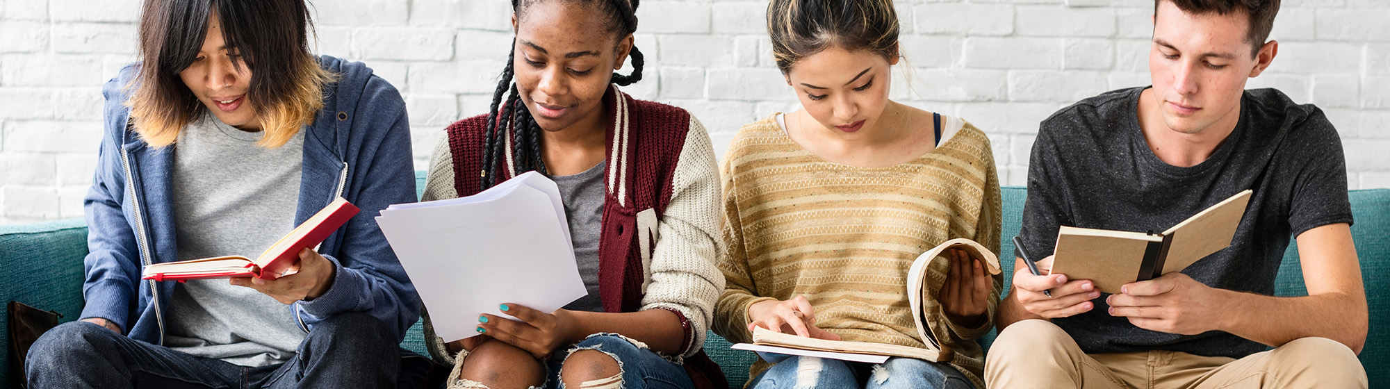 Diverse group of teenagers all reading different materials.